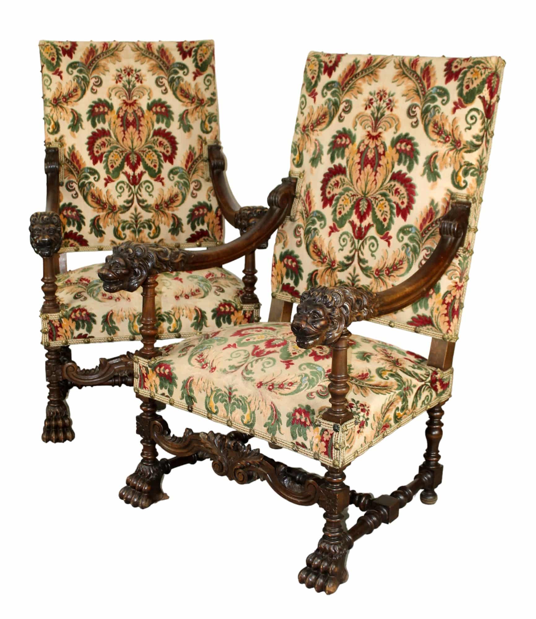 Pair of French fauteuil armchairs in walnut with carved lion heads and paw feet